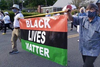 Congregants marching with a banner that reads "Black Lives Matter"